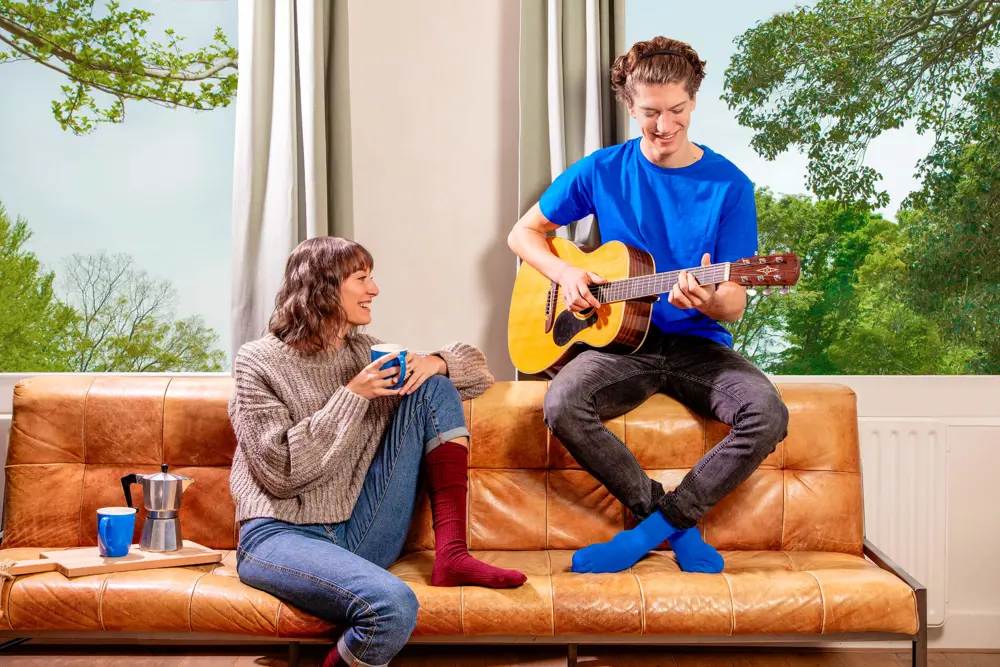 Jongen Speelt Gitaar Voor Vriendin Op Bank